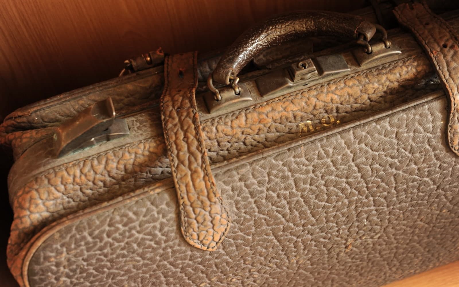 Editorial image for "The Expat Wealth Stack: What Globally Mobile Families Need Before They Move Again". Source image: Old leather suitcase, Tegarden Chocolates, Centralia, Washington, USA.