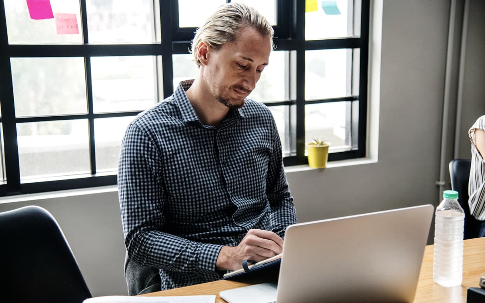 Editorial image for "The Three Conversations Every Founder Should Have Before a Liquidity Event". Source image: Businessman noting down.