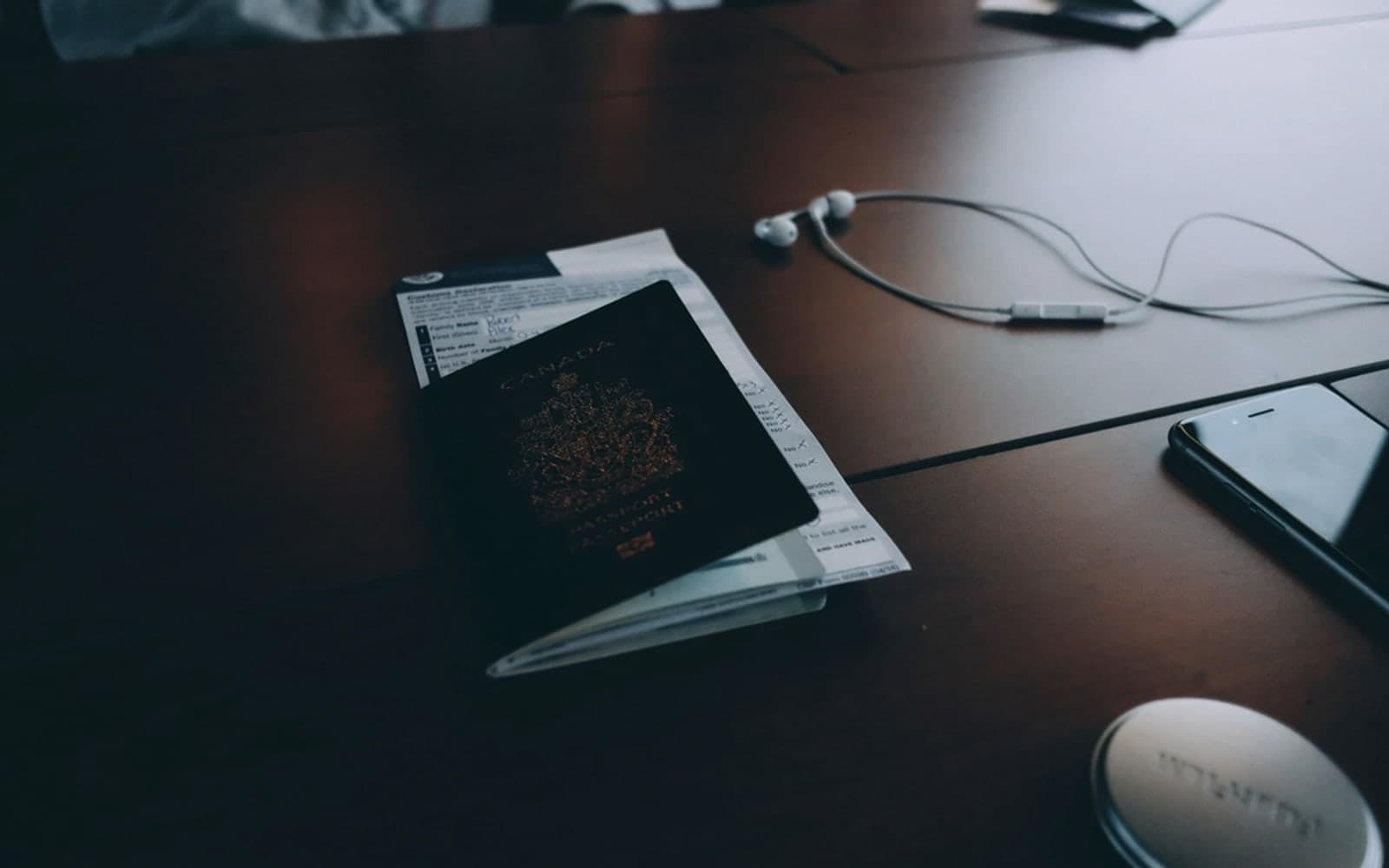 Editorial image for "Why Wealth Gets Messy After Your Second Country". Source image: Passport documents desk phone earphones.